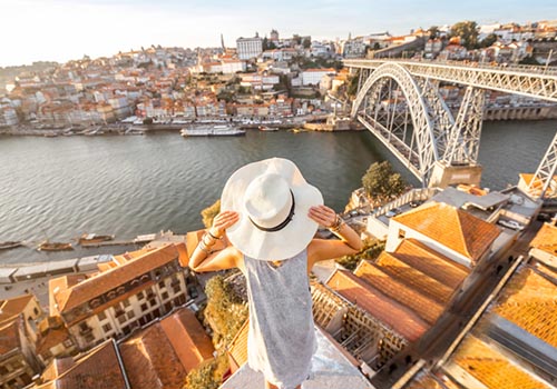 Looking don on Porto with woman tourist and big white hat Charm of Porto - Woman tourist with big, white hat overlooking Porto