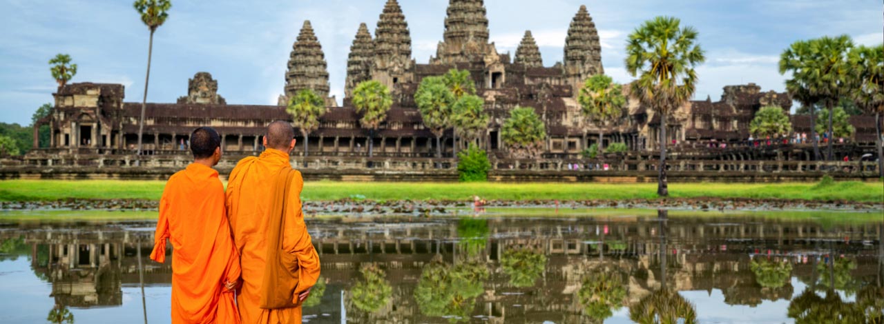 Escorted Riches of the mekong - 2 monks looking at Angkor Wat