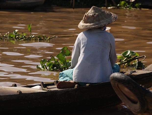 Mekong River Scene with local person in traditional hat