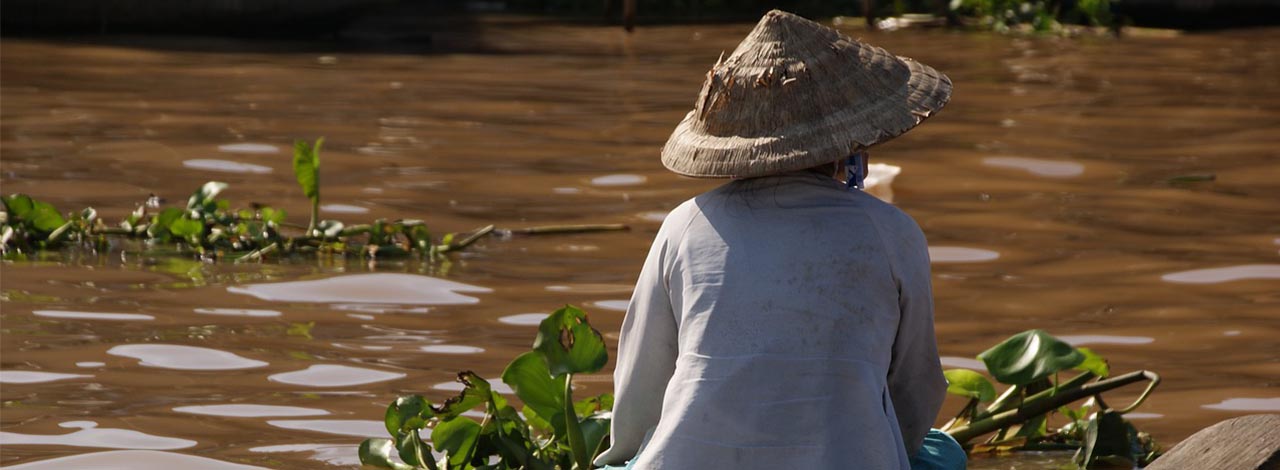 Mekong River Scene with local person in traditional hat